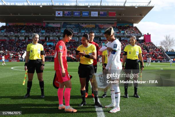 Captains Kim Hyeri of Korea Republic and Ghizlane Chebbak of Morocco attend the coin toss prior to the FIFA Women's World Cup Australia & New Zealand...
