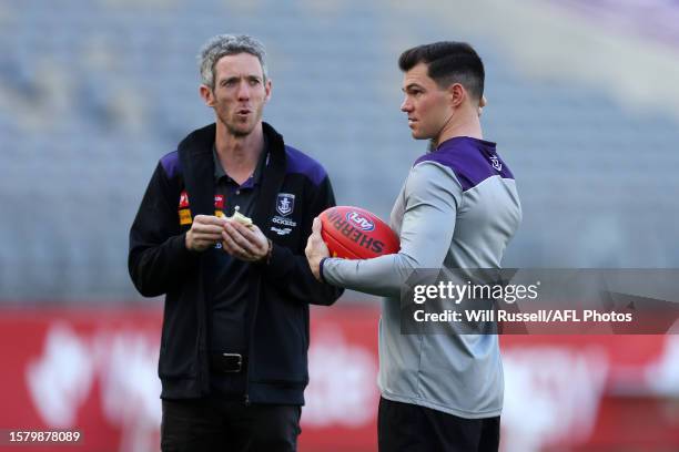 Jaeger O'Meara of the Dockers speaks with Bob Murphy the 2023 AFL Round 21 match between the Fremantle Dockers and the Brisbane Lions at Optus...