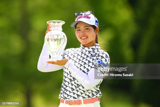 Kokona Sakurai of Japan poses with the trophy after winning the tournament following the final round of Rakuten Super Ladies at Tokyu Grand Oak Golf...