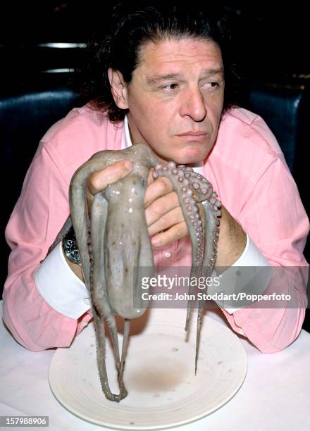 British celebrity chef Marco Pierre White poses with an octopus, circa 2003.