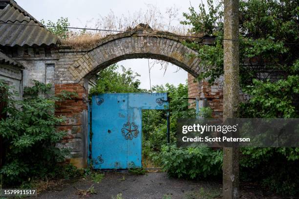 The entrance of an abandoned Ukrainian house stands in the Old Town district, which comes under frequent bombardment from Russian troops stationed on...