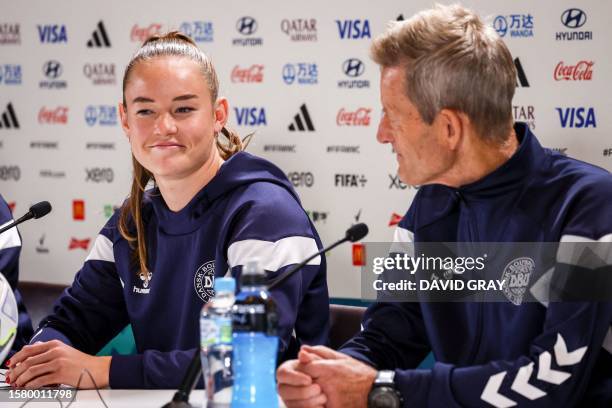 Denmark's team coach Lars Sondergaard and player Janni Thomsen attend a press conference at Stadium Australia on August 6 on the eve of the Women's...