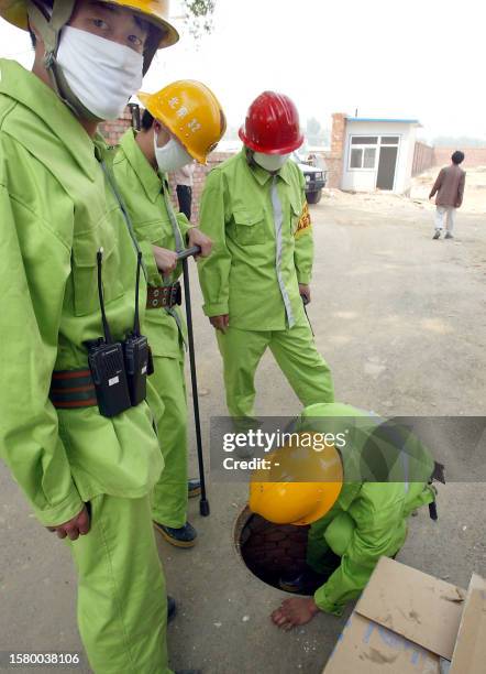 Chinese firemen install a fire hydrant at the hospital erected in barely a week to house a rapidly increasing number of Chinese patients infected...