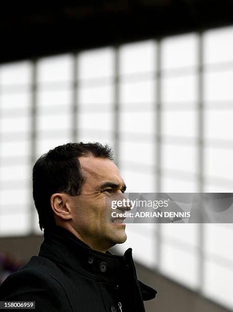 Wigan Athletic's Spanish manager Roberto Martinez looks on from the touchlines as the players take to the field during the English Premier League...