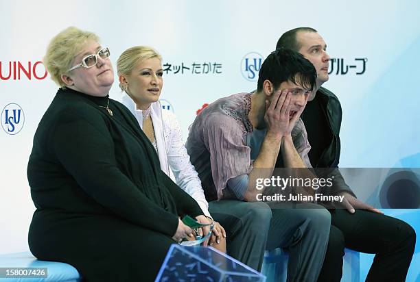 Tatiana Volosozhar and Maxim Trankov of Russia react after their performance in the Pairs Free Skating during the Grand Prix of Figure Skating Final...