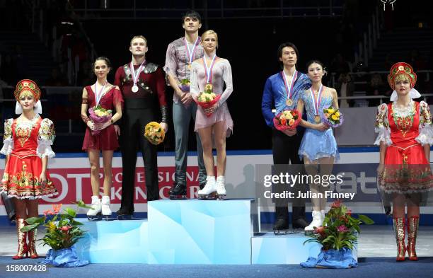 Vera Bazarova and Yuri Larionov of Russia with their silver medals, Tatiana Volosozhar and Maxim Trankov of Russia with their gold medals and Qing...