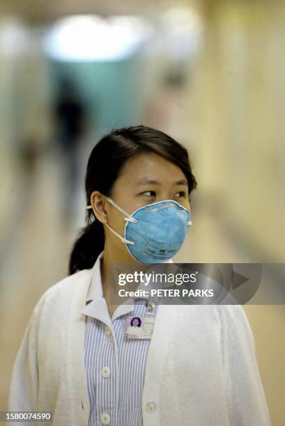 Nurse at the Prince of Wales Hospital in Sha Tin district of Hong Kong wears a surgical mask to protect against a form of pneumonia that has struck...