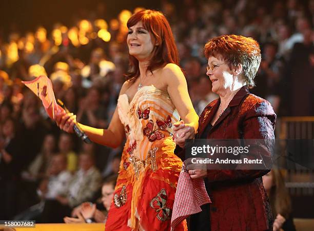 Andrea Berg and her mother Helga Zellen gesture during the Andrea Berg 'Die 20 Jahre Show' at Baden Arena on December 7, 2012 in Offenburg, Germany.