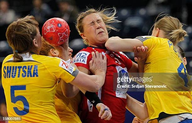 Marit Malm Frafjord of Norway is challenged by Iryna Shutska and Anastasiia Pidpalova of Ukraine during the Women's European Handball Championship...