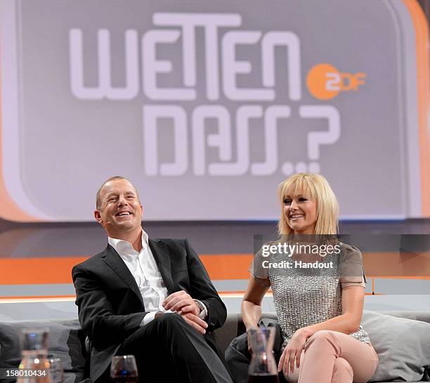 In this handout provided by the ZDF, Heino Ferch and Helene Fischer sit on the couch at 'Wetten dass..?' From Freiburg on December 8, 2012 in...