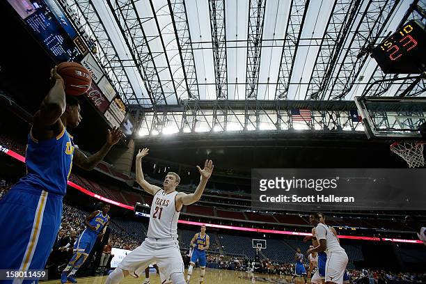 Kyle Anderson of the UCLA Bruins looks to find a teammate over Connor Lammert of the Texas Longhorns during the MD Anderson Proton Therapy Showcase...