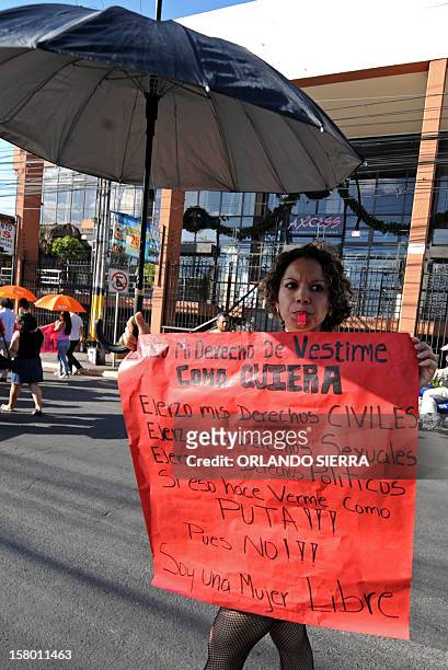 Woman holds a sign during the Marcha de las Putas on December 8, 2012 in Tegucigalpa, to protest against violence against women and demand more...