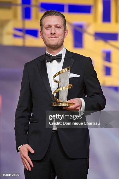 Danish film director Tobias Lindholm poses with theJury prize for the film "A Hijacking" during the award ceremony of the 12th International...