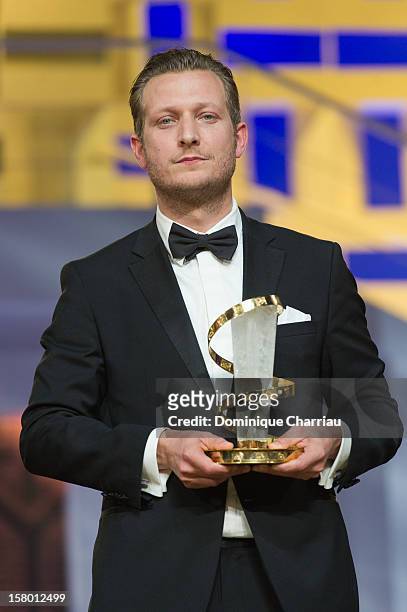 Danish film director Tobias Lindholm poses with the Jury prize for the film "A Hijacking" during the award ceremony of the 12th International...