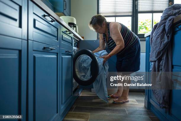 do the laundry at home with washing machine. - tumble dryer sheets stock pictures, royalty-free photos & images