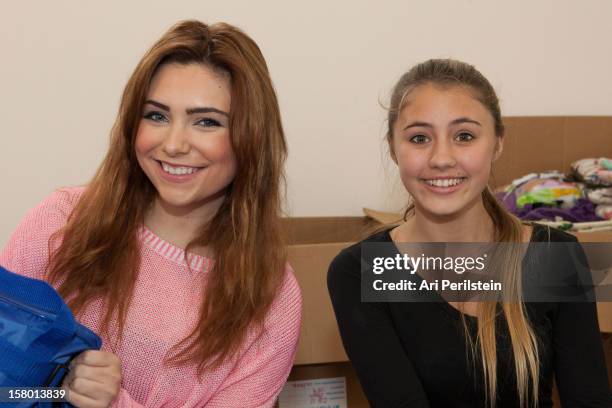 Actress Julianna Rose and Actress Lia Marie Johnson fill bags at "Kids Helping Kids" - A Celebrity Holiday Stuff-A-Thon Benefiting My Stuff Bags...