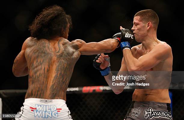 Benson Henderson punches Nate Diaz during their lightweight championship bout at the UFC on FOX event on December 8, 2012 at Key Arena in Seattle,...