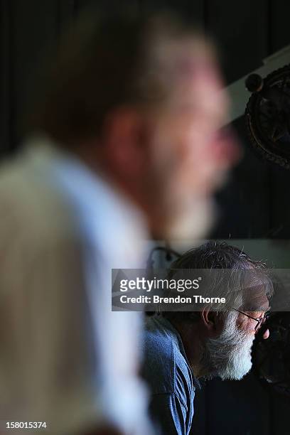 Scoreboard operators watches play during an international tour match between the Chairman's XI and Sri Lanka from inside The Jack Fingleton...