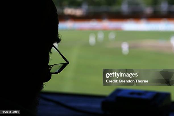 Scoreboard operator keeps score during an international tour match between the Chairman's XI and Sri Lanka from inside The Jack Fingleton Scoreboard...