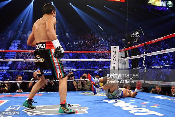 Juan Manuel Marquez knocks down Manny Pacquiao in the third round during their welterweight bout at the MGM Grand Garden Arena on December 8, 2012 in...