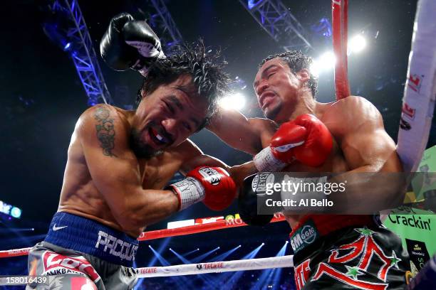 Manny Pacquiao and Juan Manuel Marquez exchange blows during their welterweight bout at the MGM Grand Garden Arena on December 8, 2012 in Las Vegas,...