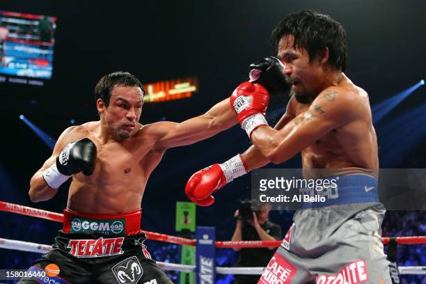 Juan Manuel Marquez throws a left to the face of Manny Pacquiao during their welterweight bout at the MGM Grand Garden Arena on December 8, 2012 in...