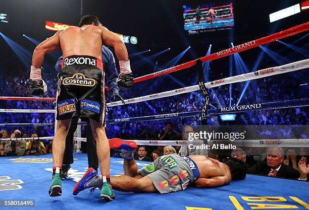 Manny Pacquiao lays face down on the mat after being knocked out in the sixth round by Juan Manuel Marquez during their welterweight bout at the MGM...