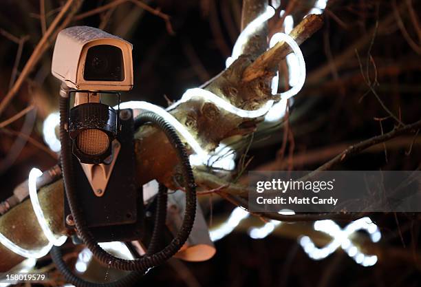 Camera watches over Christmas festive lights that adorn a detached house in a suburban street in Melksham, December 8, 2012 in Melksham, England. The...