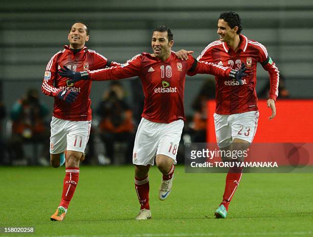 Egypt's Al-Ahly forward Abdallah Said is is congratulated by his teammates Walid Soliman and Mohamed Nagieb after his goal against Japan's San Frecce...