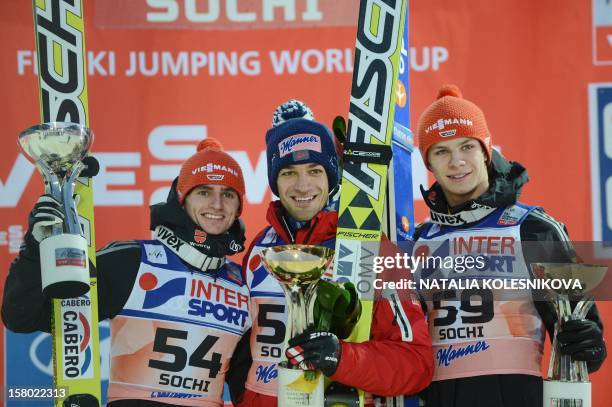Germany's Richard Freitag , Austria's Andreas Kofler and Germany's Andreas Wellinger celebrate after the men's normal hill individual at the FIS Ski...