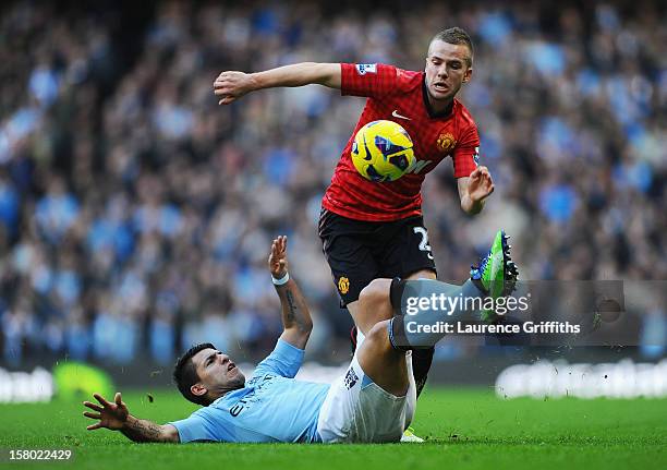 Tom Cleverley of Manchester United is challenged by Sergio Aguero of Manchester City during the Barclays Premier League match between Manchester City...
