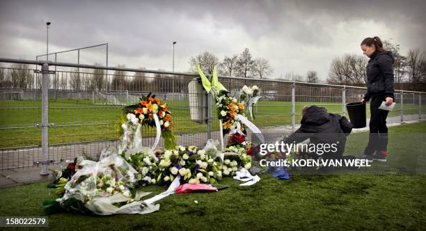 People lay flowers for linesman Richard Nieuwenhuizen at the clubhouse of Dutch football club SC Buitenboys in Almere, on December 9, 2012....