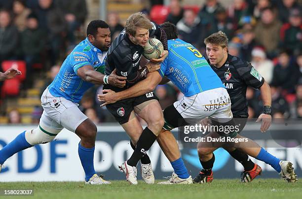 Mathew Tait of Leicester is tackled by Valerio Bernabo and Manoa Vosawai during the Heineken Cup match between Leicester Tigers and Treviso at...