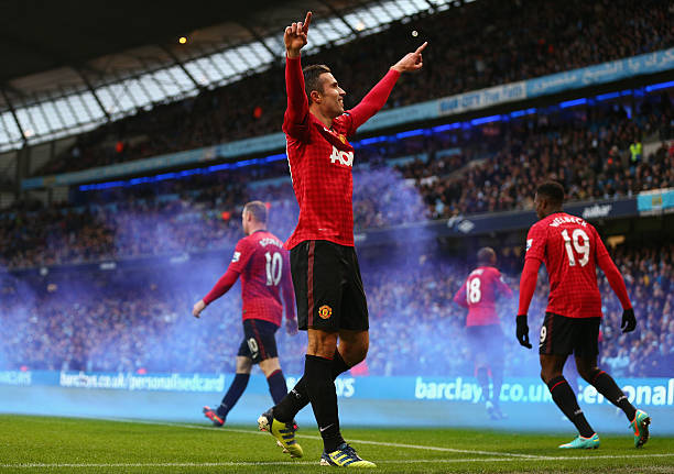 Robin van Persie of Manchester United celebrates scoring the winning goal during the Barclays Premier League match between Manchester City and...