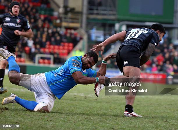 Manu Tuilagai of Tigers is evades Manoa Vosawai of Treviso to score a try during the Heineken Cup round 3 match between Leicester Tigers and Treviso...