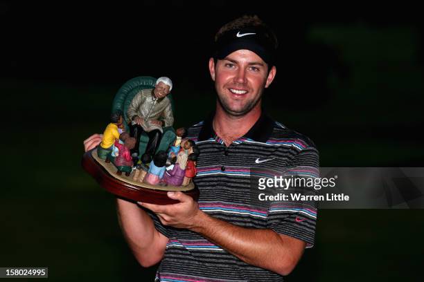 Scott Jamieson of Scotland poses with the trophy after winning The Nelson Mandela Championship presented by ISPS Handa after a three way play-off...