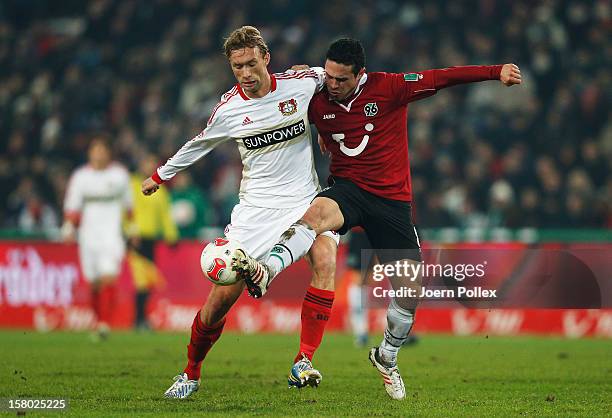 Manuel Schmiedebach of Hannover and Simon Rolfes of Leverkusen compete for the ball during the Bundesliga match between Hannover 96 and Bayer 04...