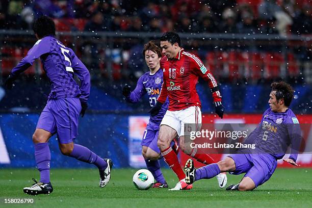 Gedo of Al-Ahly SC challenges Kohei Shimizu and Toshihiro Aoyama of Sanfrecce Hiroshima during the FIFA Club World Cup Quarter Final match between...