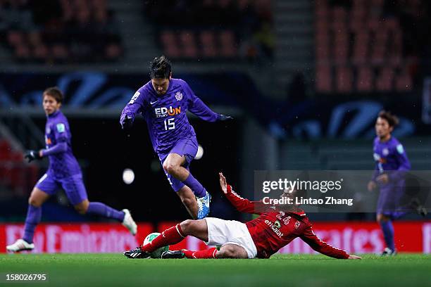 Yojiro Takahagi of Sanfrecce Hiroshima fights for the ball withAhmed Fathi of Al-Ahly during the FIFA Club World Cup Quarter Final match between...