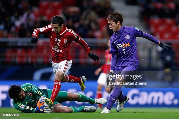 Koji Morisaki of Sanfrecce Hiroshima challenges with Ahmed Kenawi and Sherif Ekramy of Al-Ahly SC during the FIFA Club World Cup Quarter Final match...