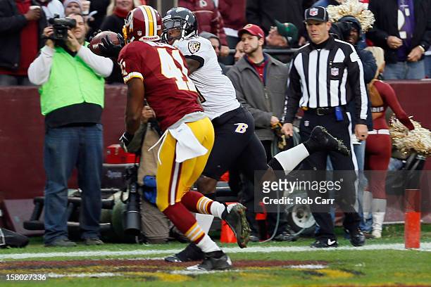 Wide receiver Anquan Boldin of the Baltimore Ravens catches a touchdown pass in front of free safety Madieu Williams of the Washington Redskins...