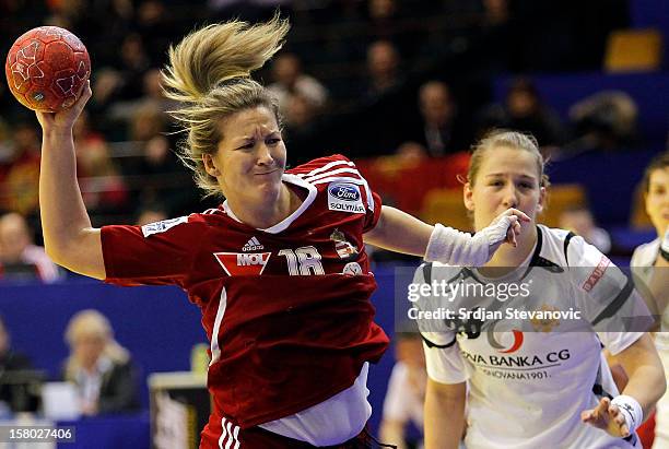 Piroska Szamoransky of Hungary jump to scores near Suzana Lazovic of Montenegro during the Women's European Handball Championship 2012 Group II main...