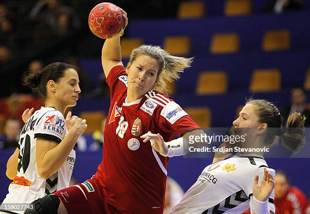Piroska Szamoransky of Hungary is challenged by Andjela Bulatovic of Montenegro during the Women's European Handball Championship 2012 Group II main...