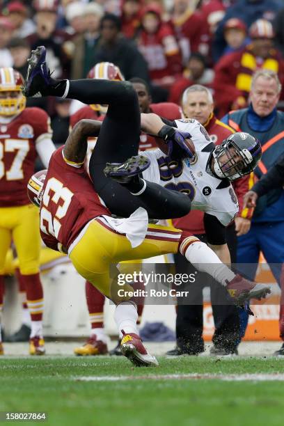 Tight end Dennis Pitta of the Baltimore Ravens is tackled by cornerback DeAngelo Hall of the Washington Redskins after catching a first half pass at...