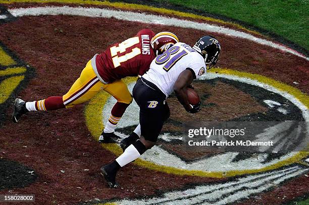 Anquan Boldin of the Baltimore Ravens is tackled by Madieu Williams of the Washington Redskins after catching a pass for a touchdown in the first...