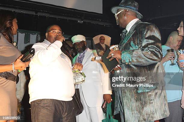 Producer L.T. Hutton receives the lifetime acheivement award from Bishop Don "Magic" Juan during The Official International Players Ball 2012 and...