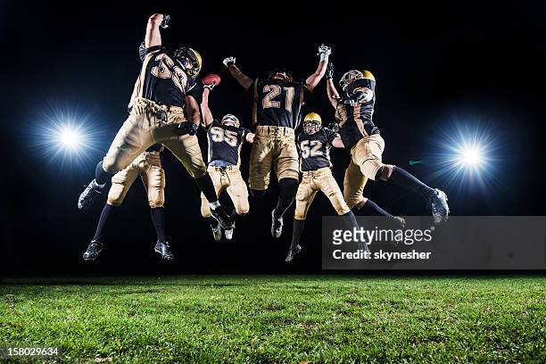 american football players celebrating their victory. - sports team stock pictures, royalty-free photos & images