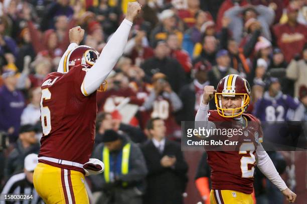 Kicker Kai Forbath of the Washington Redskins celebrates with holder Sav Rocca after hitting the game winning field goal in overtime to give the...
