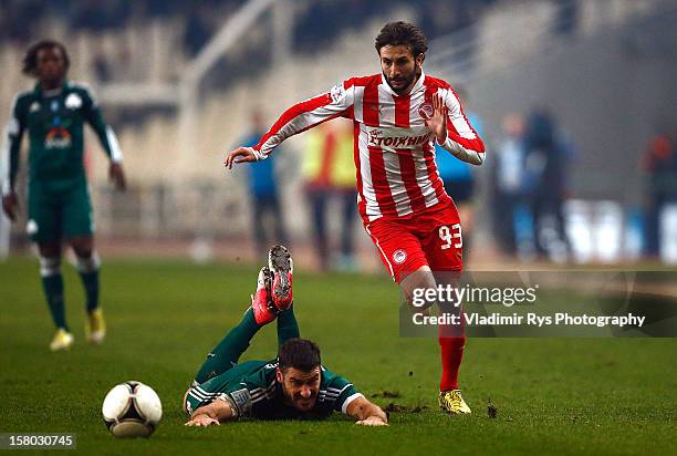 Giorgos Seitaridis of Panathinaikos falls as Djamel Abdoun of Olympiacos attacks during the Superleague match between Panathinaikos FC and Olympiacos...