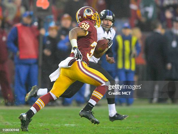 Washington Redskins returner Richard Crawford brings a punt back 64 yards before being brought down by Baltimore Ravens punter Sam Koch during the...